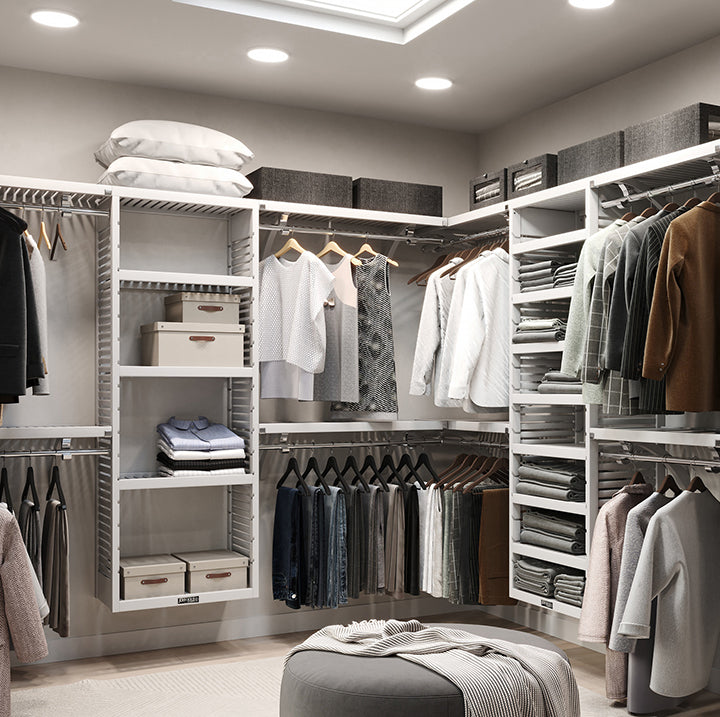 Image of a large custom walk in closet organized and created with white John Louise Home closet organizers
