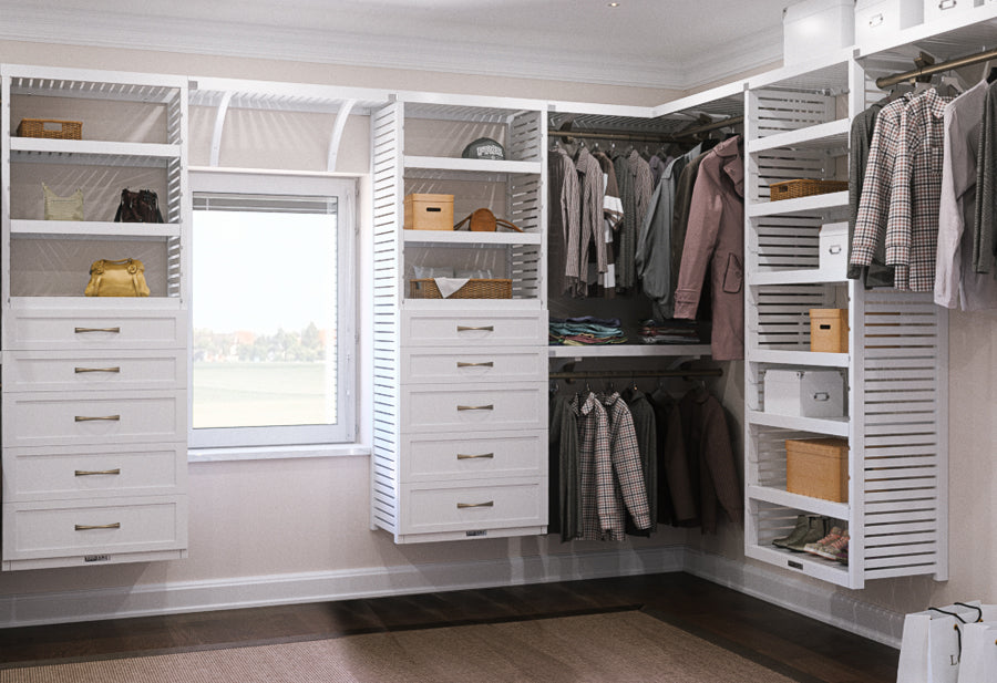 large walk in closet with white closet system